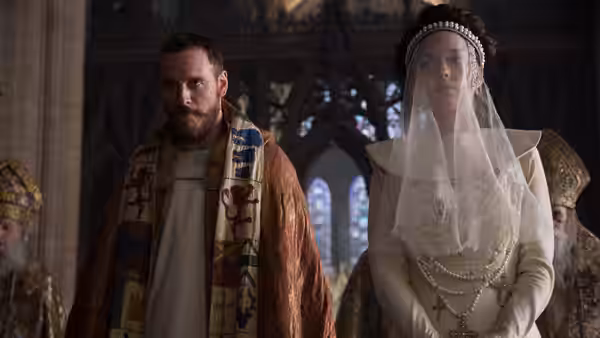 Macbeth (Michael Fassbender) and Lady Macbeth (Marion Cotillard) standing together in a cathedral