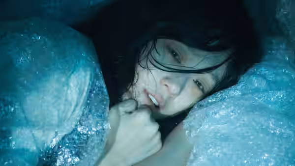 Kim Jung-yeon (Jung Ryeo-won) peers out from beneath translucent plastic bags
