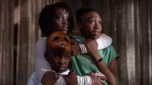 Adelaide Wilson (Lupita Nyong'o) with two children looking upward in fear