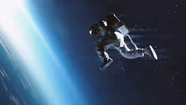An astronaut tumbles through space with Earth and sunlight in the background
