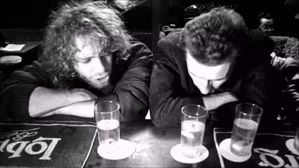 Rémy (Rémy Belvaux) and Ben resting heads on a bar counter