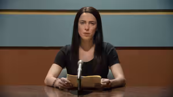 Christine Chubbuck (Rebecca Hall) speaking at a desk with microphone