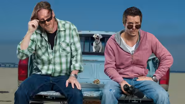 Hank Dolworth (Donal Logue) and Britt Pollack (Michael Raymond-James) on the tailgate of a pickup truck