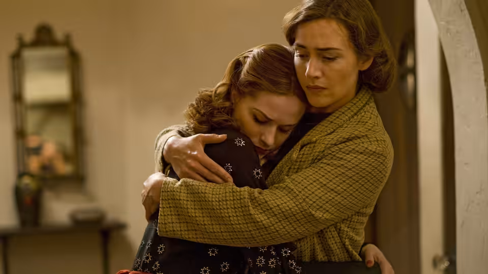 Mildred Pierce (Kate Winslet) embracing Veda Pierce (Evan Rachel Wood)