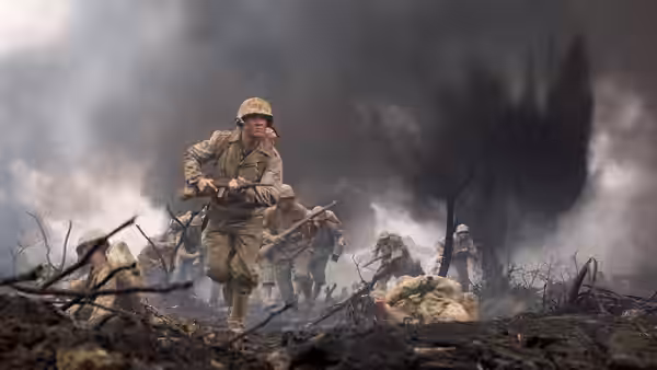 Lead soldier running forward across a smoky ruined battlefield landscape