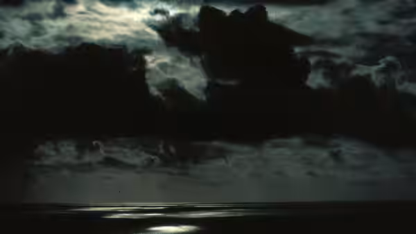 Dark storm clouds over a moonlit calm ocean at night