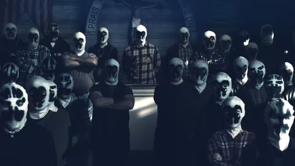 Group of masked figures in white hoods gathered inside a wooden hall with crucifix