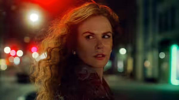 Grace Fraser (Nicole Kidman) turns on a neon-lit city street at night