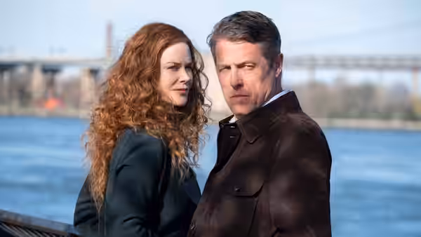 Grace Fraser (Nicole Kidman) and Jonathan Fraser (Hugh Grant) stand by the river