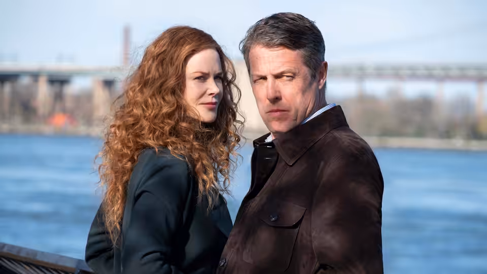Grace Fraser (Nicole Kidman) and Jonathan Fraser (Hugh Grant) stand by the river