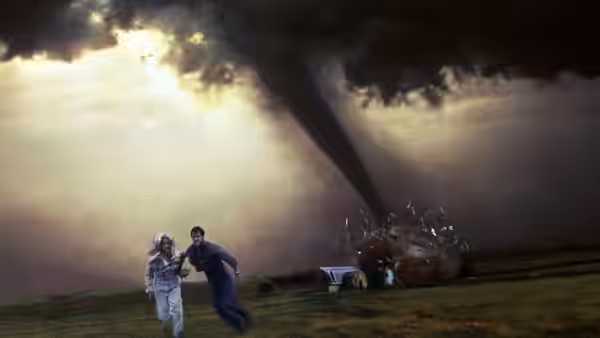 Jo (Helen Hunt) and Bill (Bill Paxton) run across a field from a towering tornado