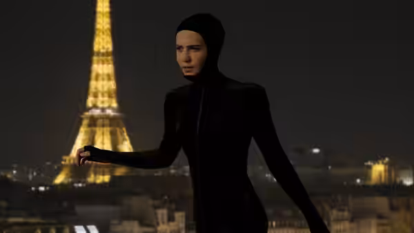Mira (Alicia Vikander) standing with arm extended before the Eiffel Tower at night