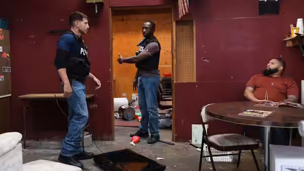 Sgt. Wayne Jenkins (Jon Bernthal) faces two men in a red room