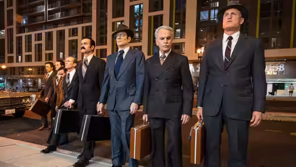 E. Howard Hunt (Woody Harrelson), G. Gordon Liddy (Justin Theroux) and other suited men stand outside at night with briefcases