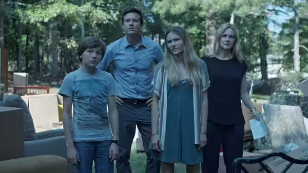 Marty Byrde (Jason Bateman) stands with his family outdoors among furniture