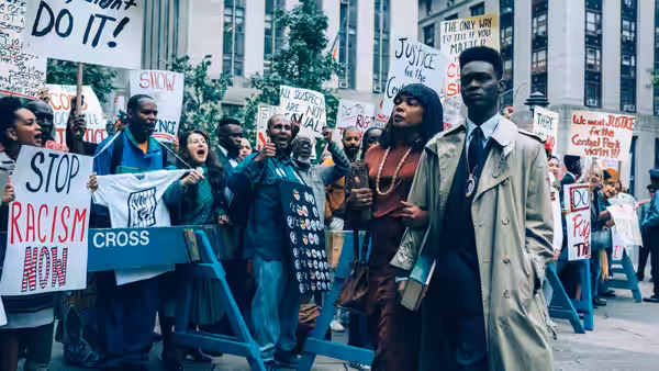 Protesters holding signs demanding justice outside city buildings