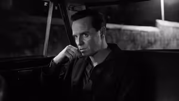 Tom Ripley (Andrew Scott) sits in a car looking out the window