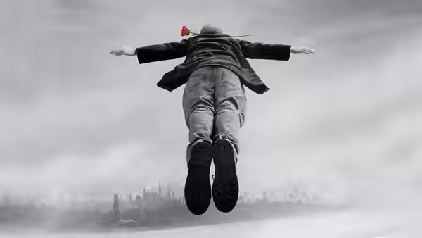 A person soaring through the sky above a city skyline