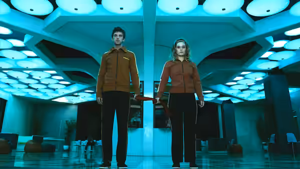 David Haller (Dan Stevens) and Sydney Barrett (Rachel Keller) standing in a blue-lit lobby
