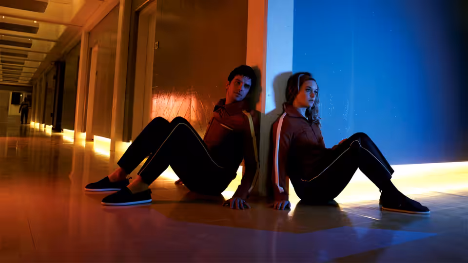 David Haller (Dan Stevens) and Sydney Barrett (Rachel Keller) sitting back to back in a hallway