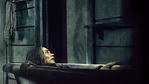 Evelyn Abbott (Emily Blunt) reclining in a bathtub looking upwards