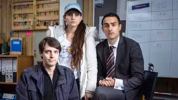 Al, Sophie Charalambos (Natasia Demetriou) and Stath Charalambos (Jamie Demetriou) pose in an office