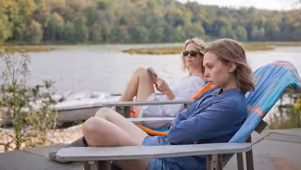 Martha (Elizabeth Olsen) and Lucy (Sarah Paulson) relax in chairs by a lake
