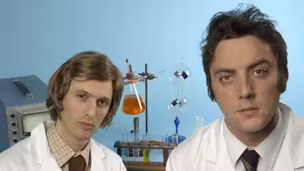 Jack Morgan (Robert Popper) and Peter Packard (Peter Serafinowicz) in lab coats