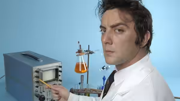 Peter Packard (Peter Serafinowicz) with lab equipment and orange liquid