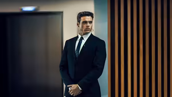 David Budd (Richard Madden) leaning against a wall with hands clasped