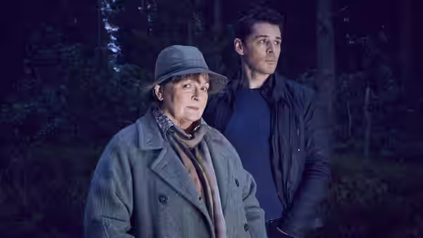 DCI Vera Stanhope (Brenda Blethyn) with a man standing in a dark forest