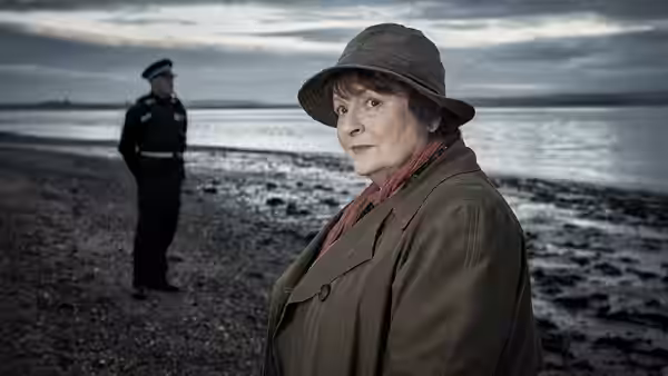 DCI Vera Stanhope (Brenda Blethyn) on a beach with a police officer in the distance