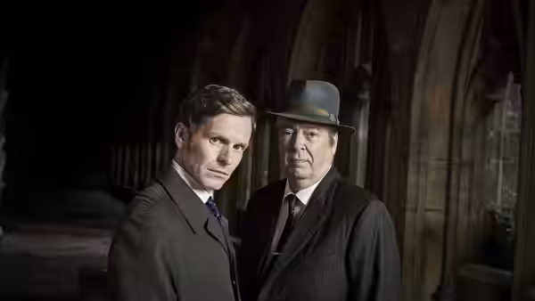 DC Endeavour Morse and DI Fred Thursday standing in a stone arched corridor