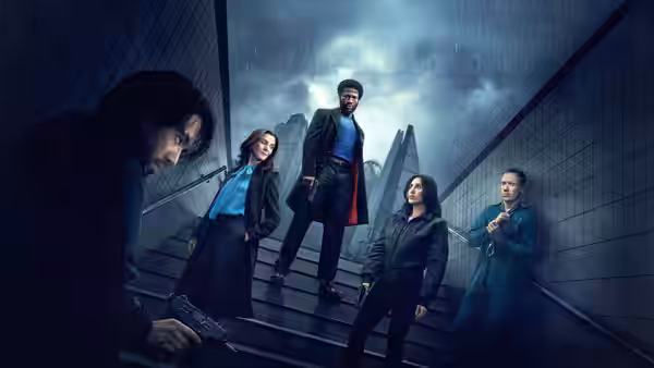 Five people stand on rain-slicked outdoor stairs with one aiming a pistol