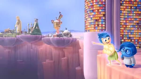 Joy pointing ahead while standing with Sadness on a ledge above the mind world