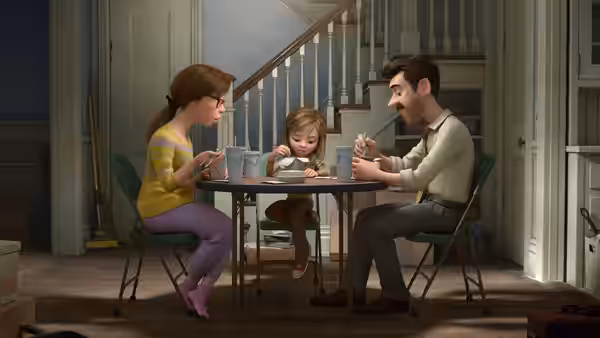 Mom, Dad and young Riley eating dinner together at the kitchen table