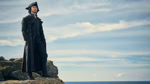 Ross Poldark (Aidan Turner) stands alone on a rocky cliff by the sea