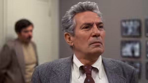 Howard Beale (Peter Finch) looking aside in gray jacket and tie