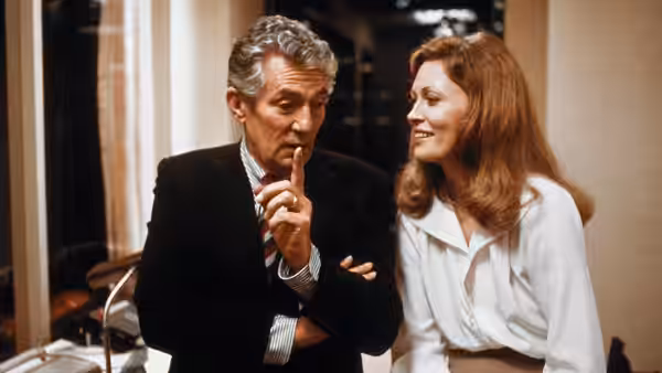 Max Schumacher (William Holden) gesturing beside Diana Christensen (Faye Dunaway)