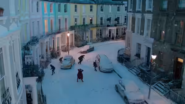 People move among parked cars on a London street