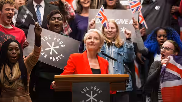 Vivienne Rook (Emma Thompson) stands at a podium before cheering supporters