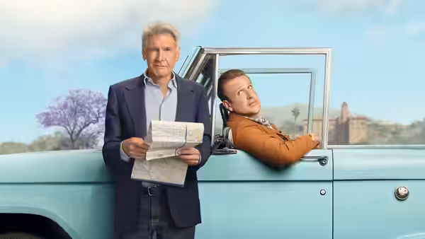 Dr. Paul Rhodes (Harrison Ford) holding a map by a blue truck with Jimmy (Jason Segel)