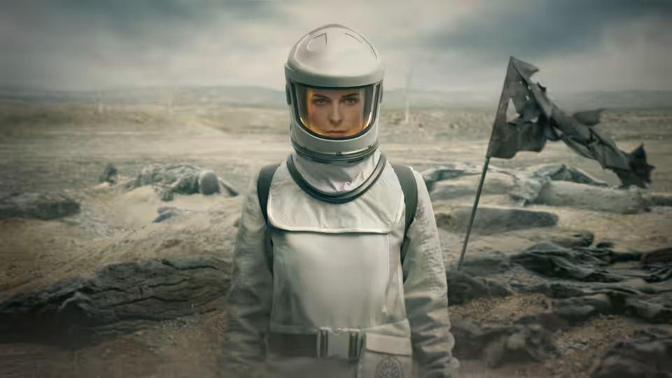 Juliette Nichols (Rebecca Ferguson) standing in a spacesuit on barren rocky ground