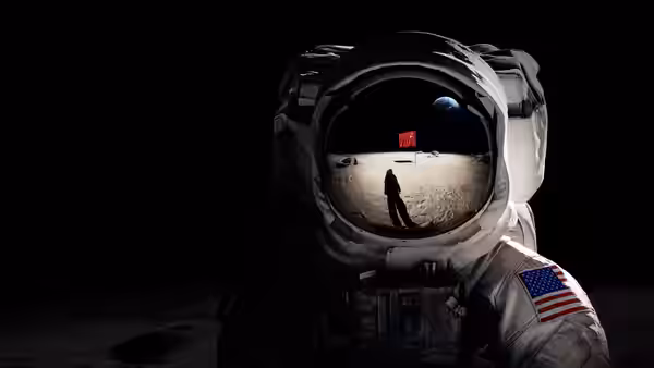 Helmet reflection shows astronaut planting flag on lunar surface