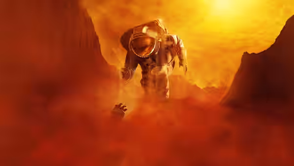 Astronaut reaches forward through swirling red dust on rocky terrain