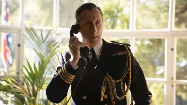 Admiral John Godfrey (Jason Isaacs) speaks on a telephone in uniform