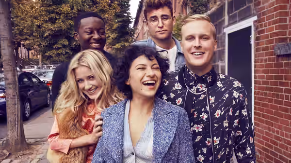 Dory Sief (Alia Shawkat) stands with friends on a city sidewalk