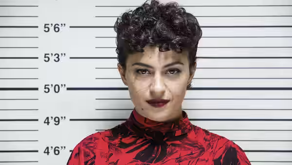 Dory Sief (Alia Shawkat) faces forward against a height chart