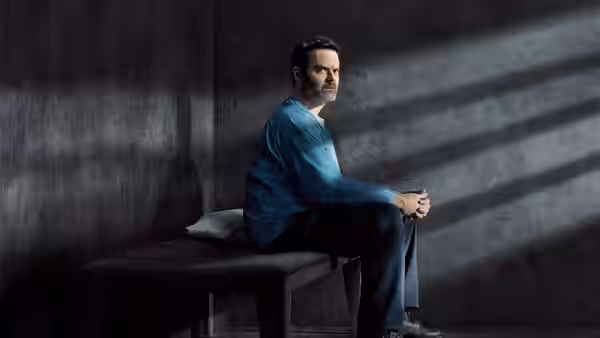 Barry Berkman (Bill Hader) sits on a bench with hands clasped