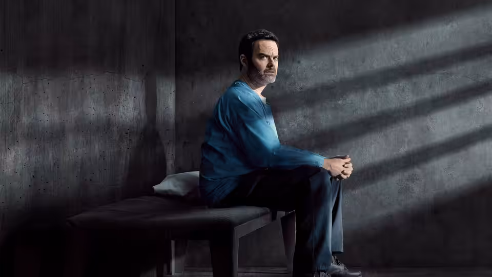 Barry Berkman (Bill Hader) sits on a bench with hands clasped